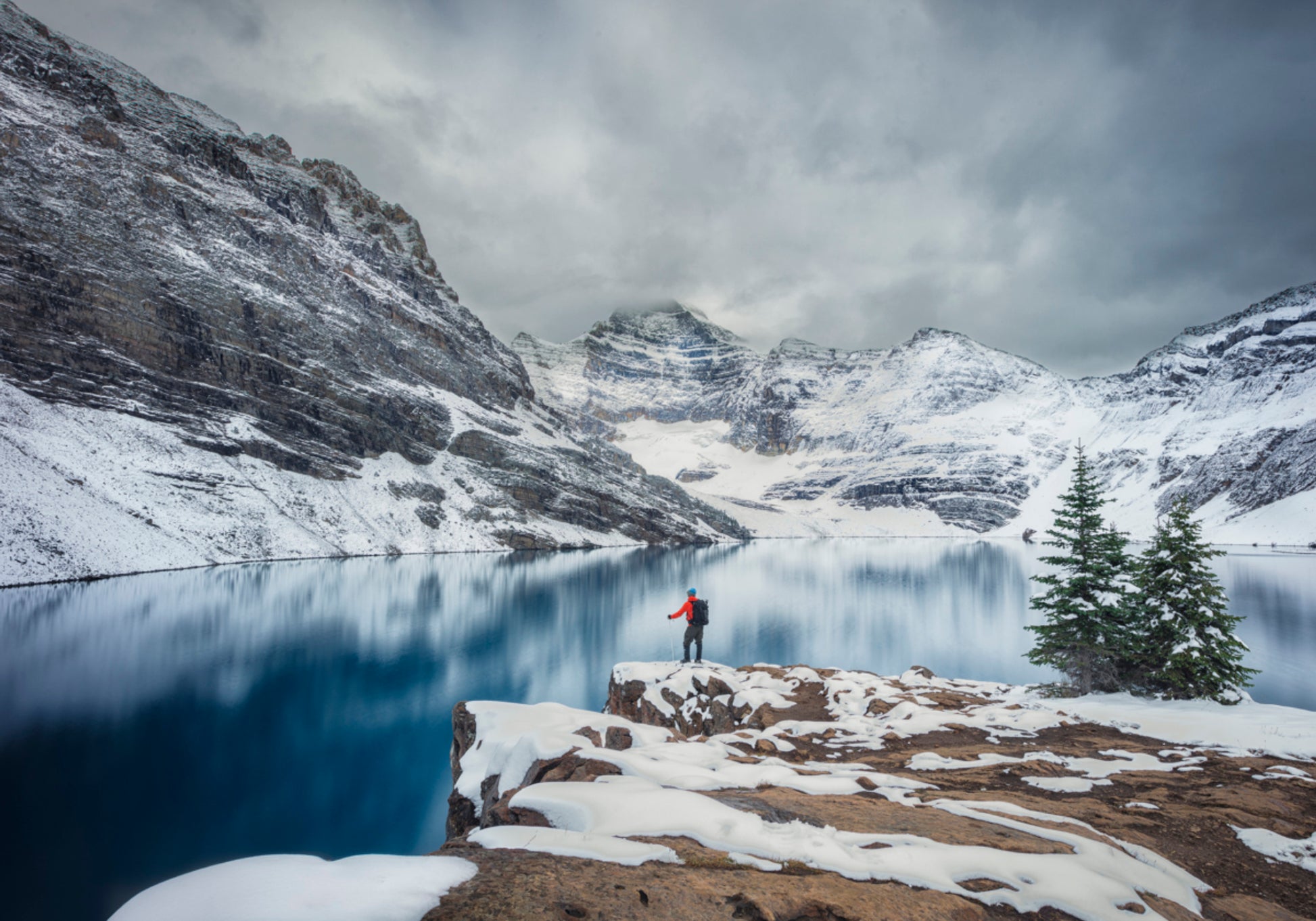Hiker At Snowy Lake